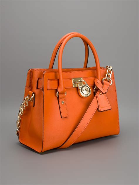 Michael Kors orange handbags